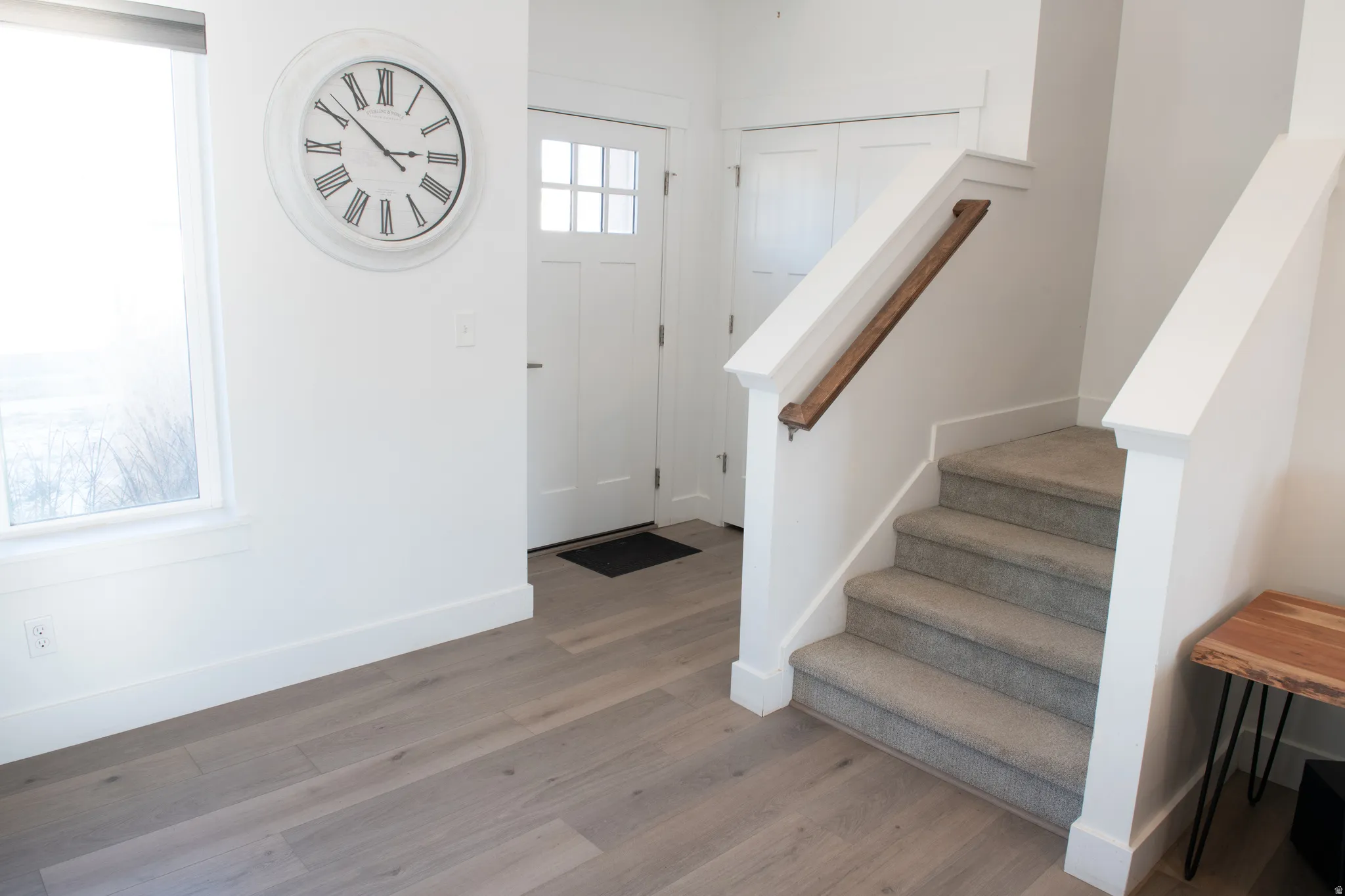 Foyer with light wood-style flooring and stairway