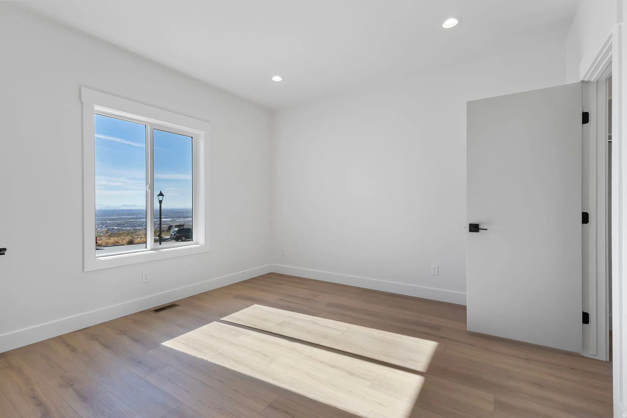 Unfurnished room featuring light wood-type flooring and recessed lighting