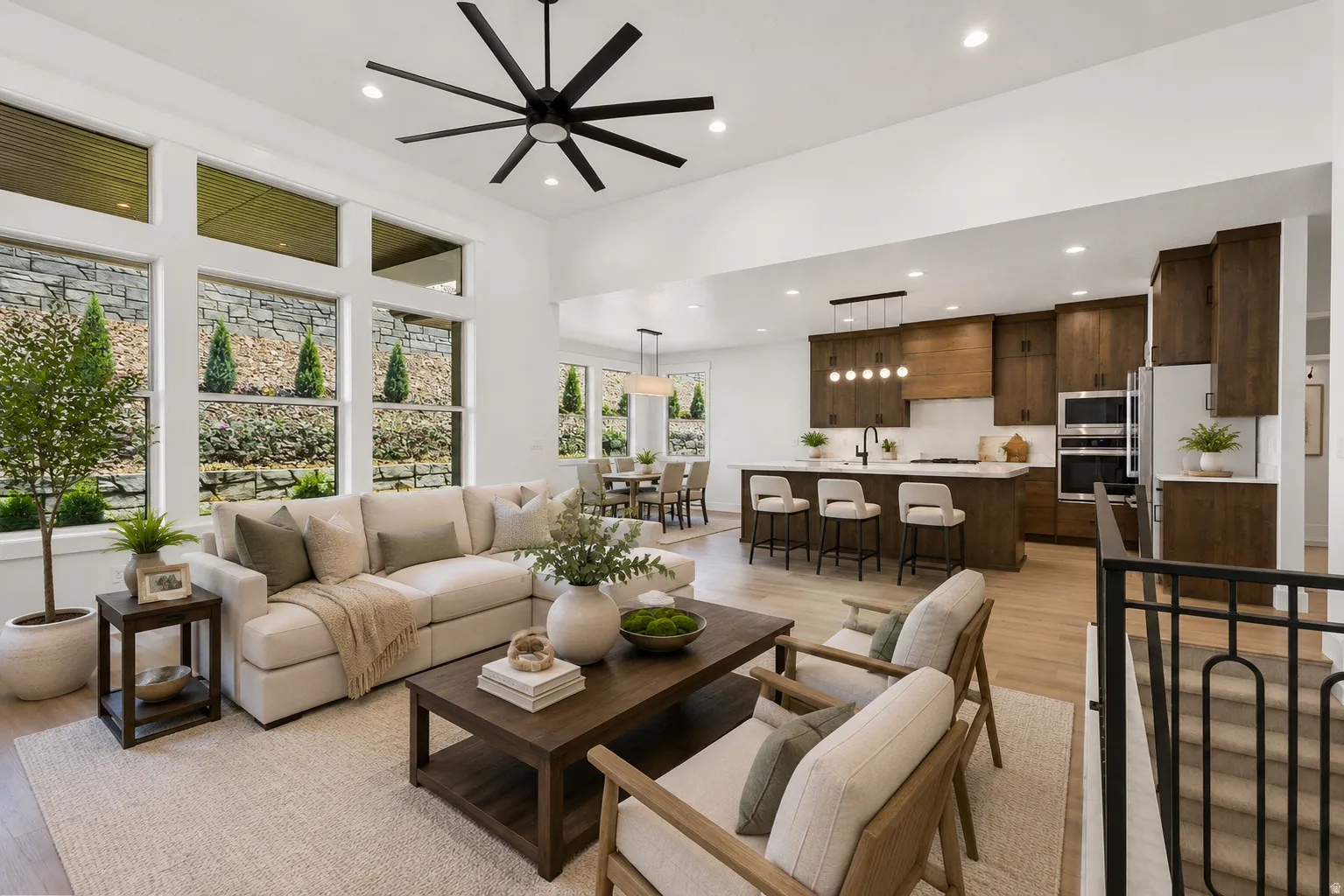 Open-concept living area with wood-finish flooring and high ceilings
