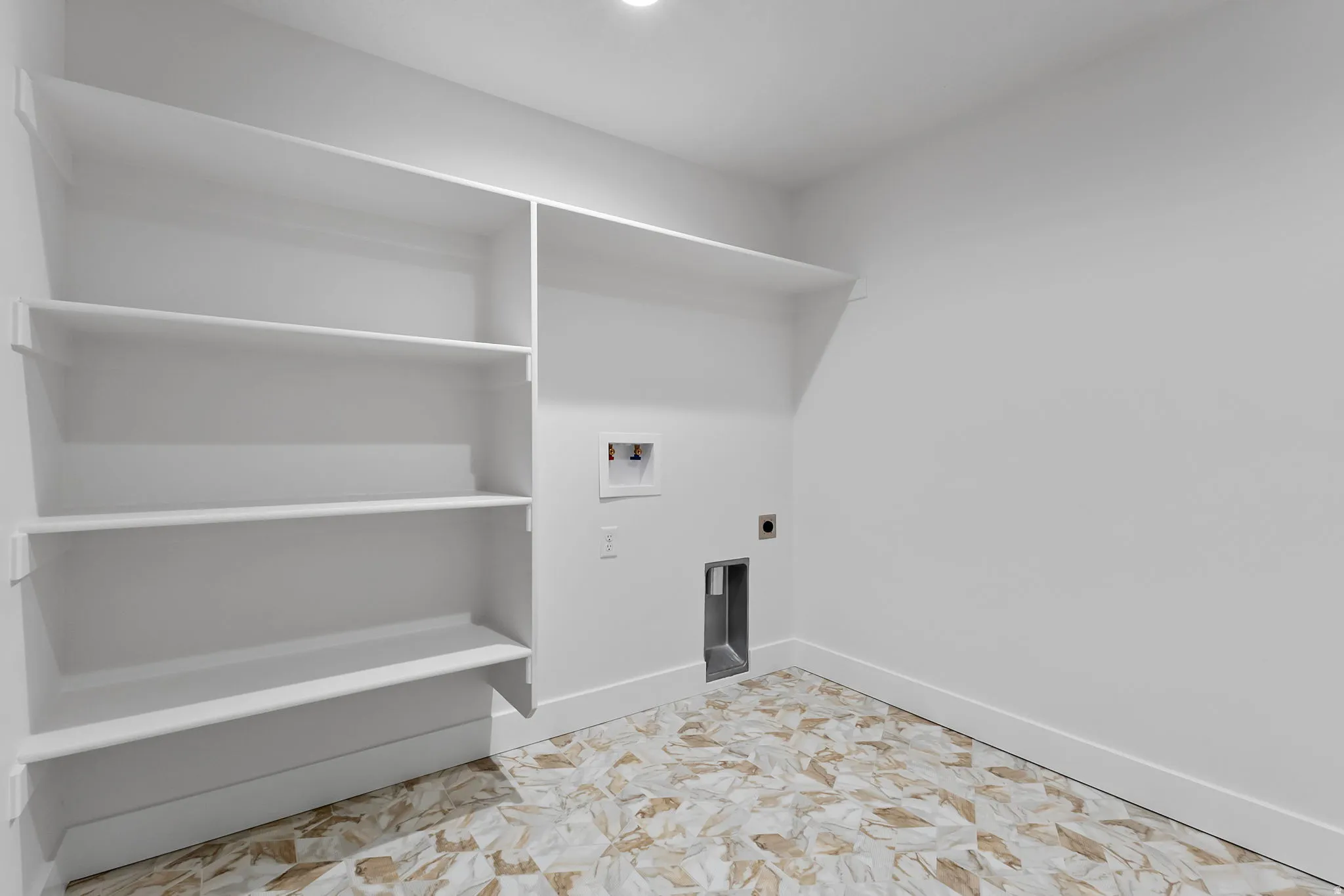 Washroom with hookup for a washing machine and hookup for an electric dryer