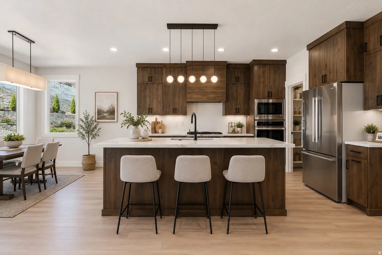 Modern kitchen featuring dark wood-finish cabinetry, a large center island with white stone countertop, integrated stainless steel appliances, and wood-finish flooring