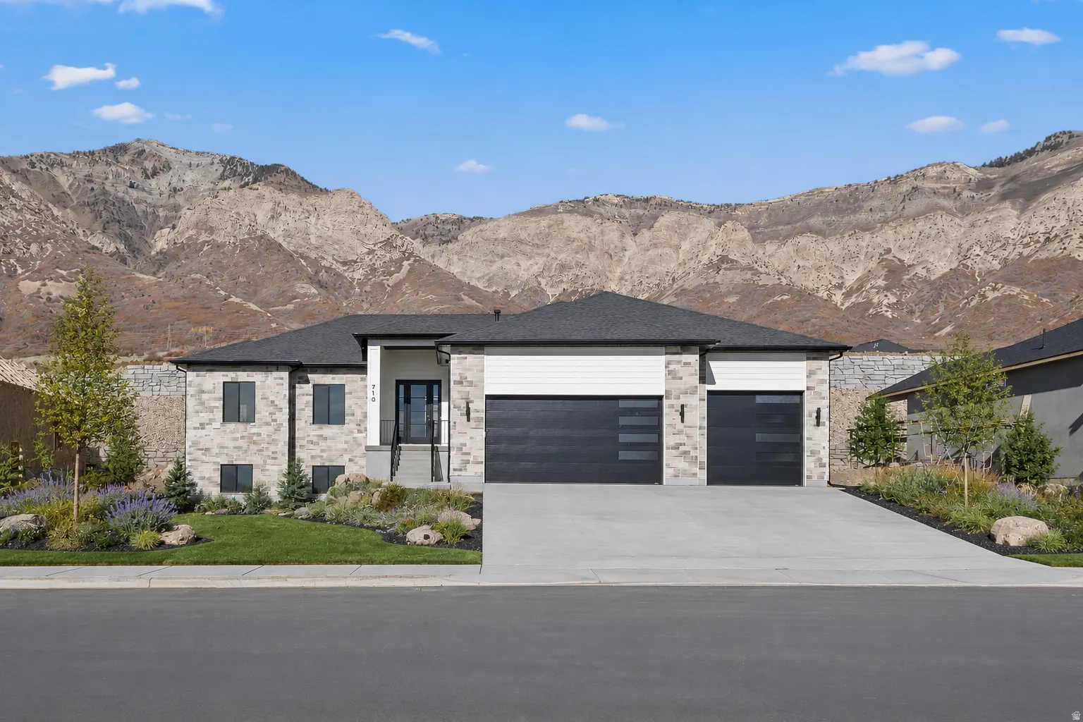 Contemporary single-story residence featuring a stone and siding facade