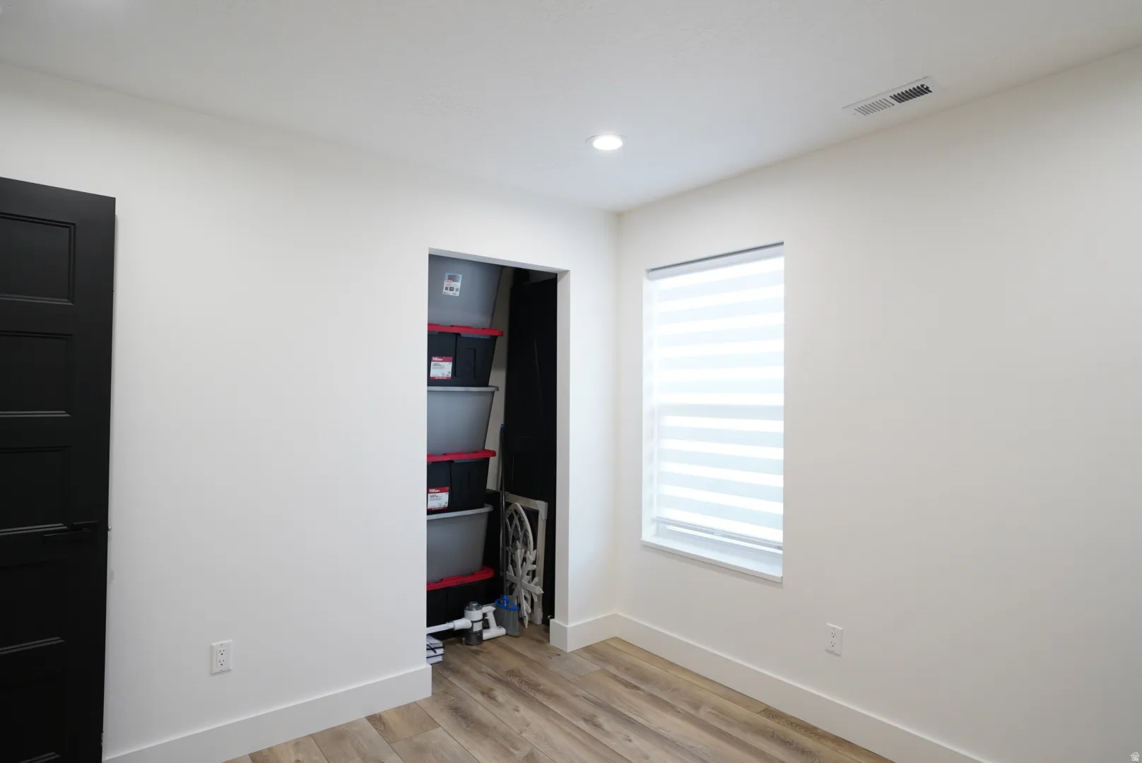 Unfurnished bedroom featuring light wood-style floors, recessed lighting, and a closet