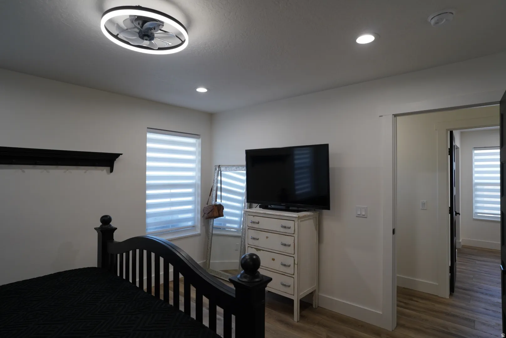 Bedroom with light wood-type flooring and recessed lighting