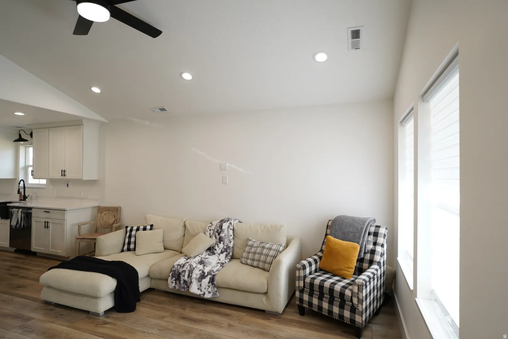 Living area with recessed lighting, wood finished floors, ceiling fan, and vaulted ceiling