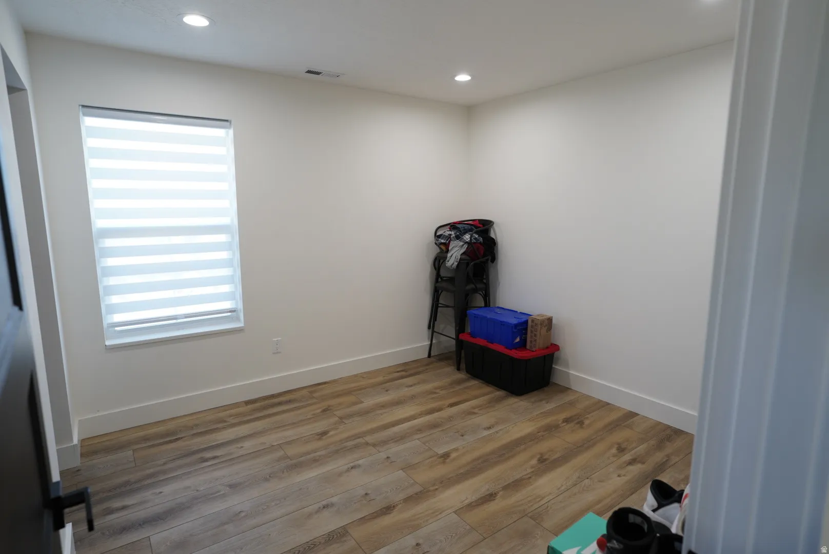 Misc room with light wood finished floors and recessed lighting