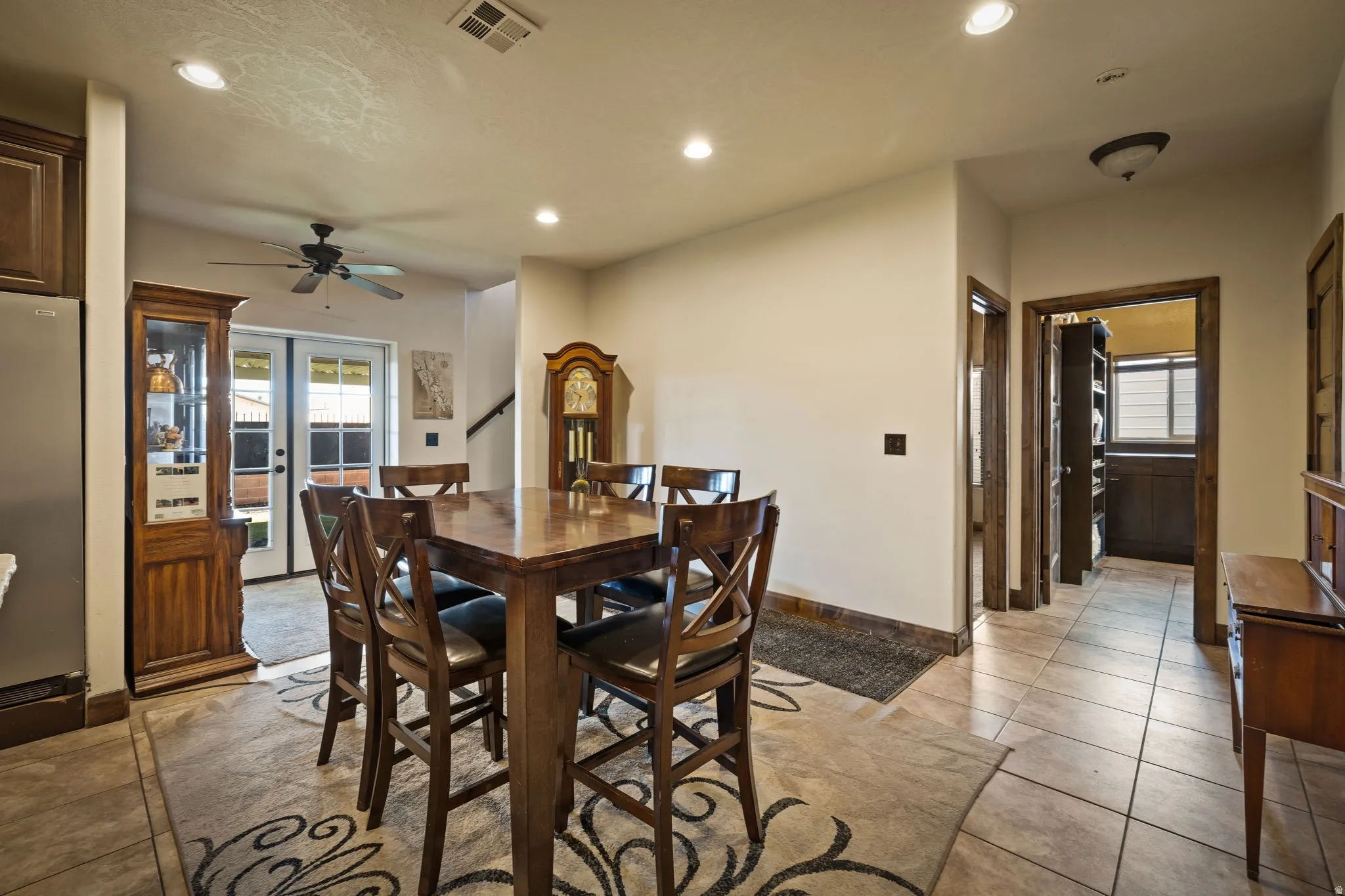 Dining space with healthy amount of natural light, recessed lighting, french doors, light tile patterned flooring, and a ceiling fan