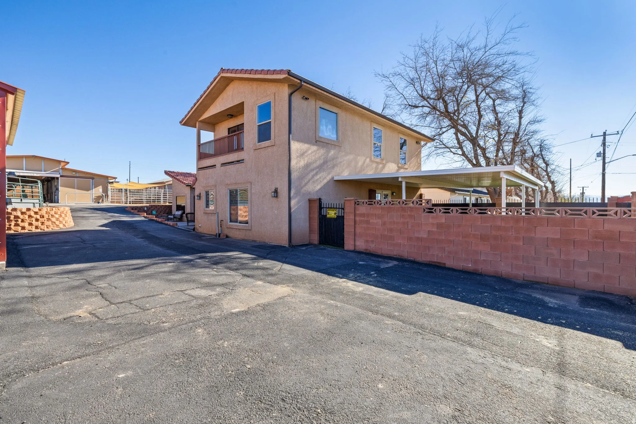 View of side of property featuring stucco siding and a balcony