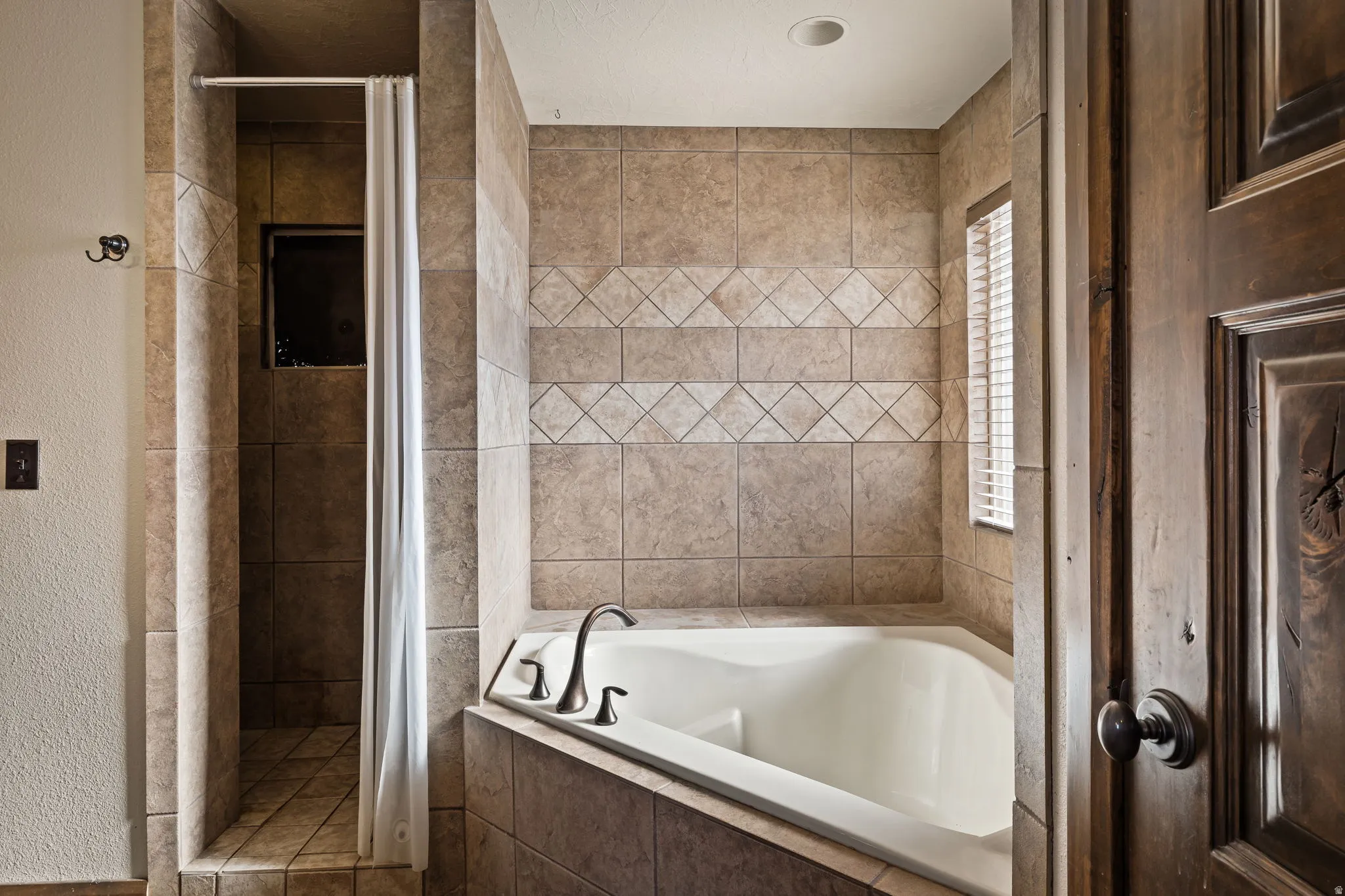 Master Full bathroom with a garden tub, a shower stall, and a textured wall