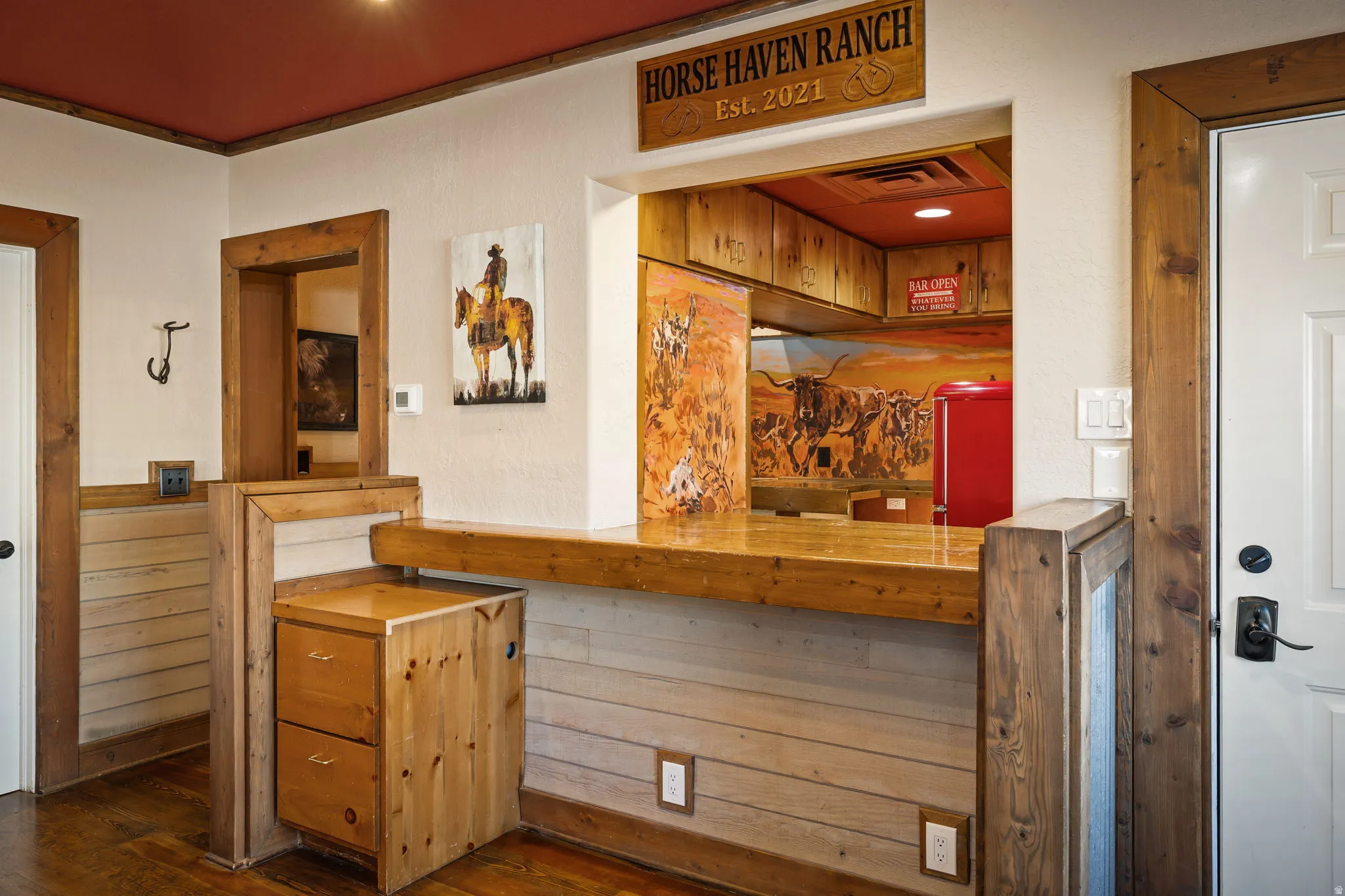 Bedroom suite - Bar featuring wooden counters, wooden walls, refrigerator, and a wainscoted wall