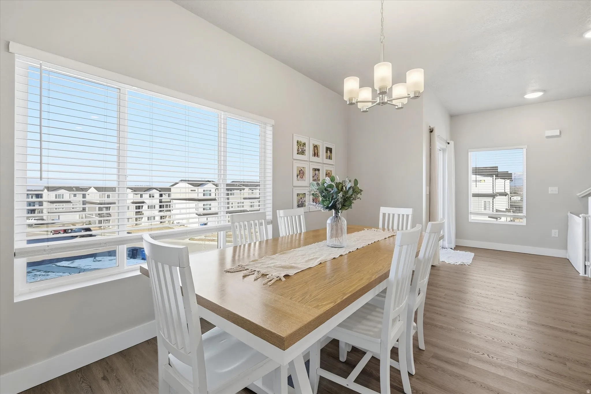 Dining area with wood finished floors and a chandelier