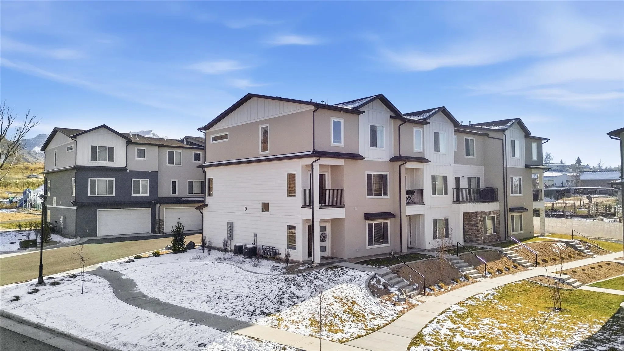 Snow covered property featuring a residential view and an attached garage