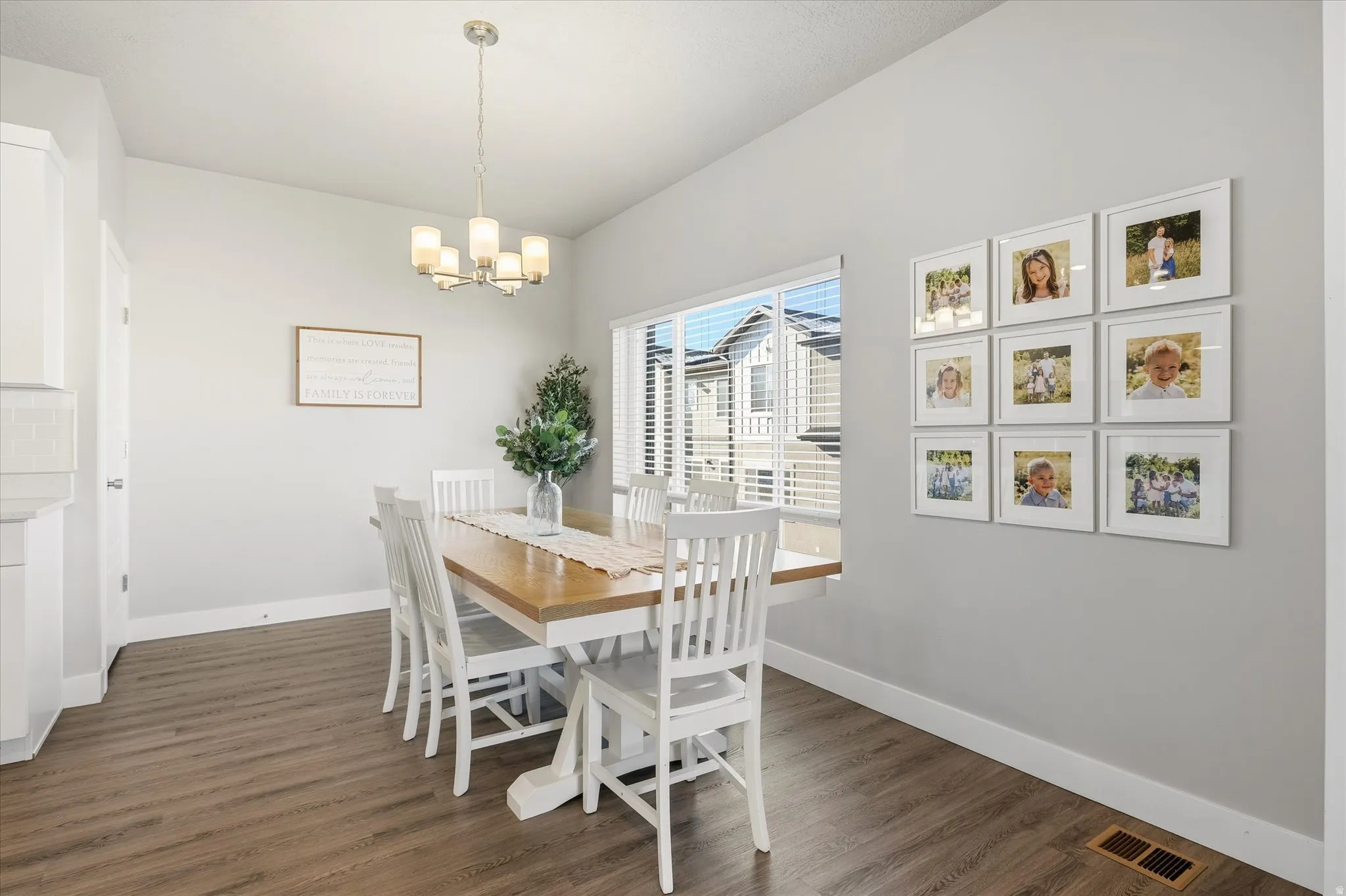 Dining area featuring dark wood finished floors and a chandelier