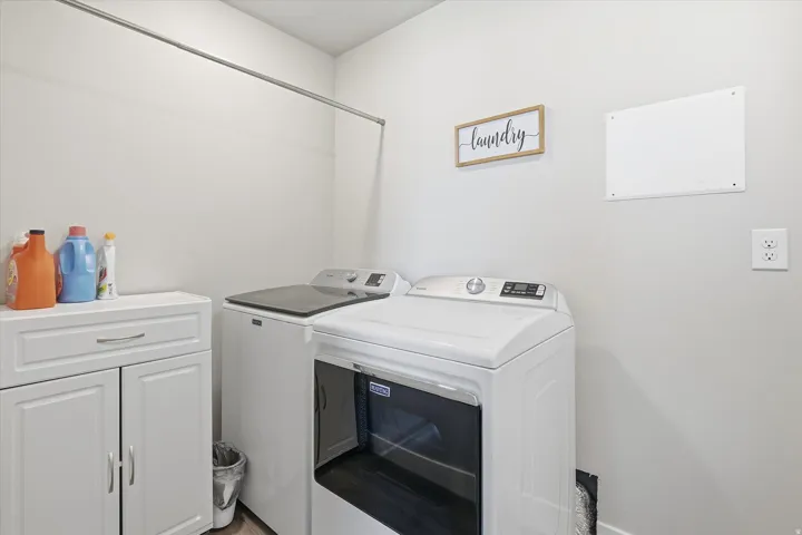 Laundry area with cabinet space and washing machine and clothes dryer