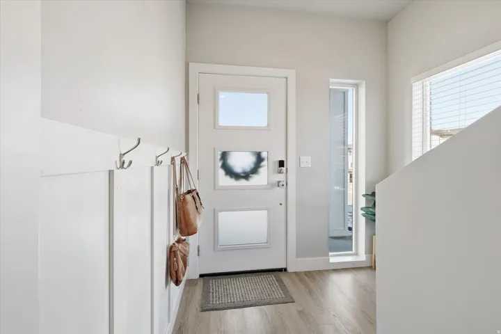 Foyer with plenty of natural light and light wood-style flooring