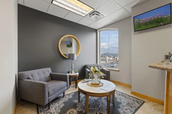 Living area featuring a paneled ceiling and baseboards