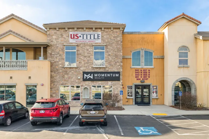 View of commercial property with uncovered parking