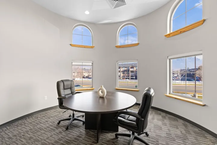 Home office with a high ceiling and recessed lighting