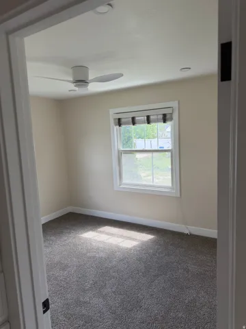 Carpeted room featuring a white ceiling fan and recessed lighting