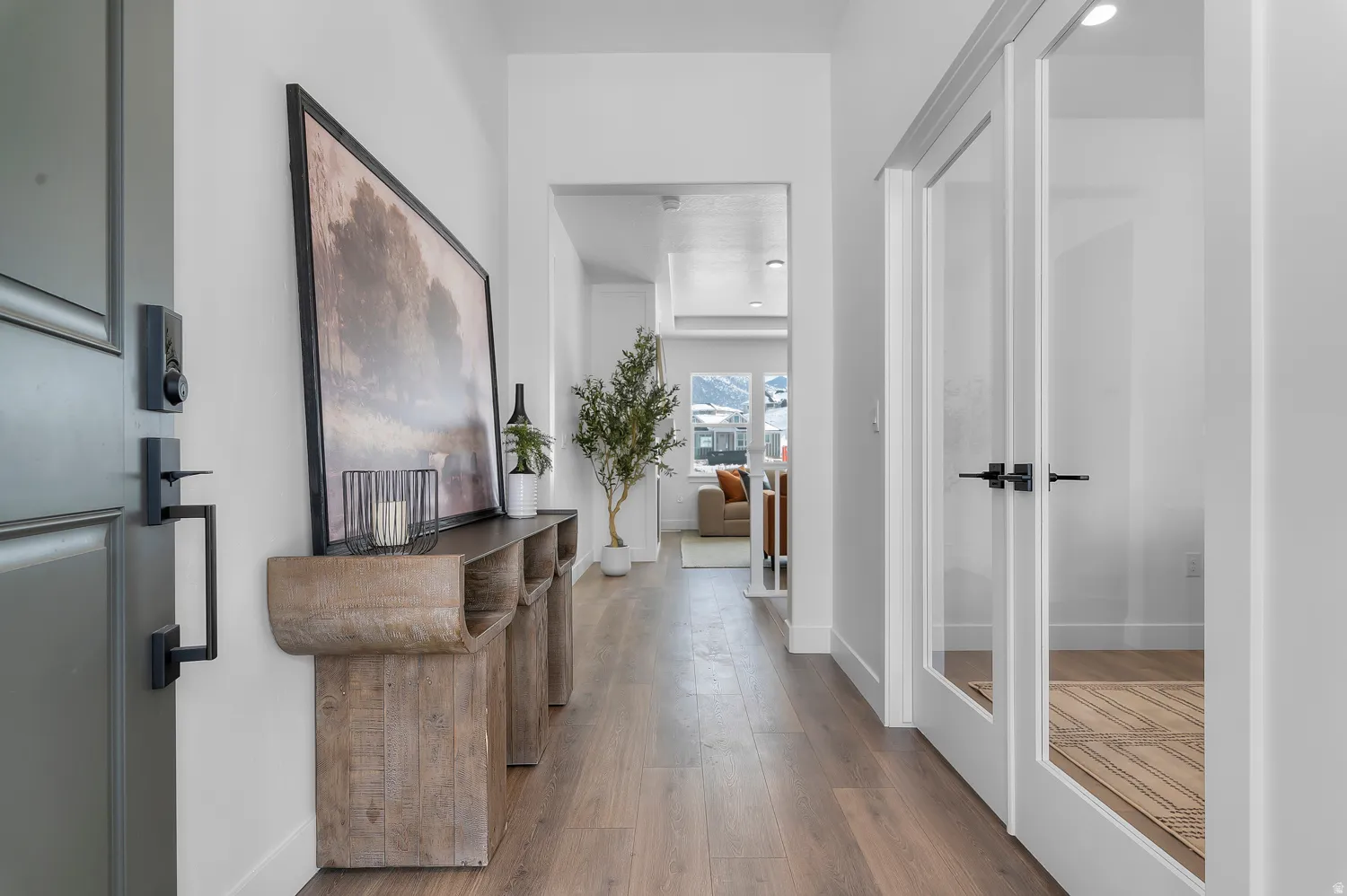 Hall featuring hardwood / wood-style flooring and baseboards