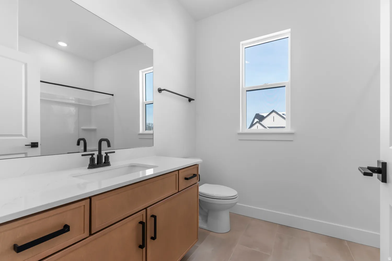 Bathroom featuring vanity and a shower