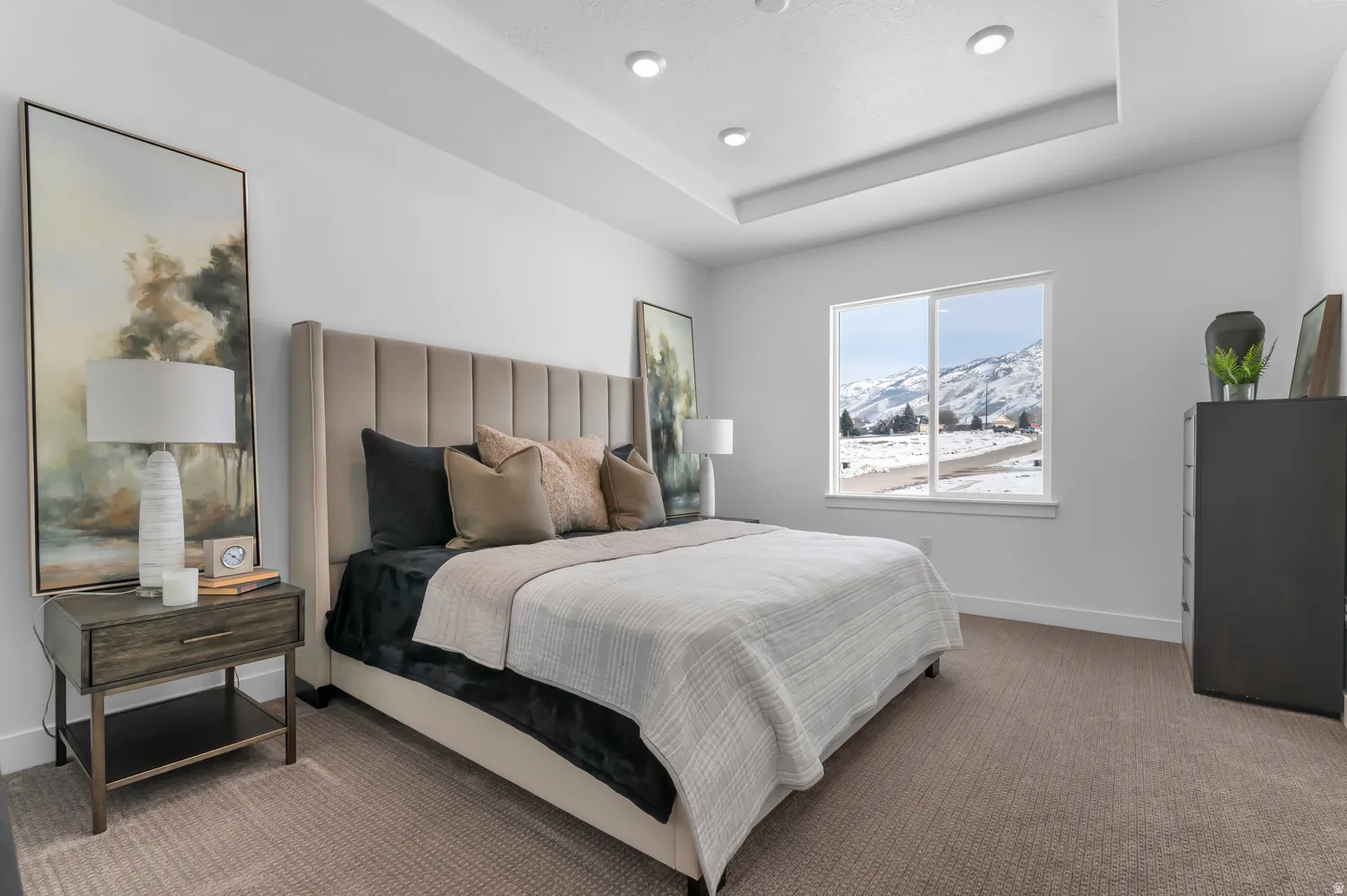 Bedroom with a mountain view, carpet floors, and a tray ceiling