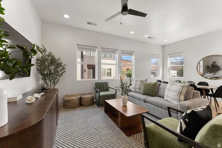 Living room with a ceiling fan and recessed lighting