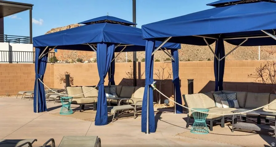 Fenced backyard with outdoor lounge area, a patio, and a gazebo