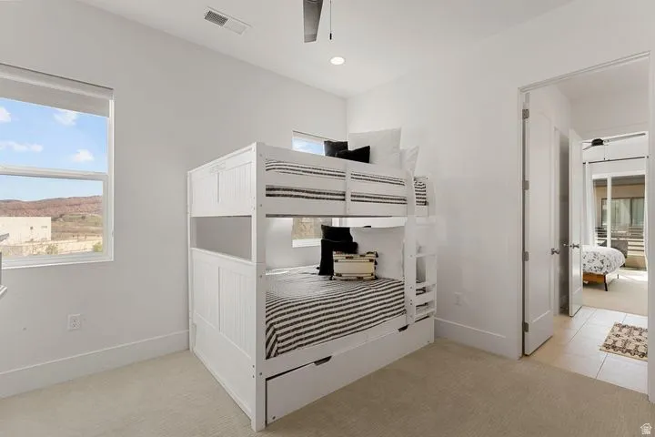 Unfurnished bedroom with light carpet and baseboards