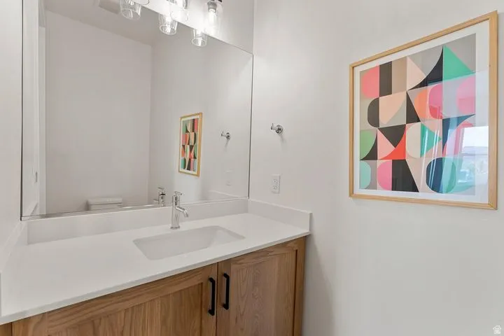 Half bathroom with vanity and toilet