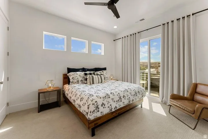 Carpeted bedroom featuring ceiling fan, access to exterior, and recessed lighting