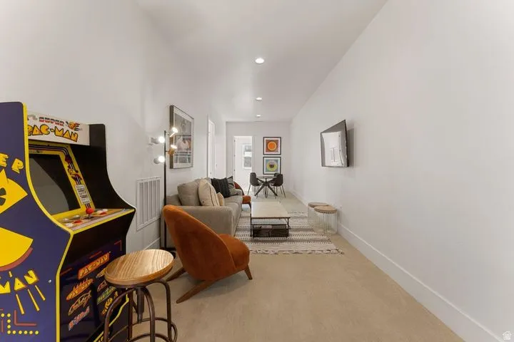 Living area with carpet flooring and recessed lighting