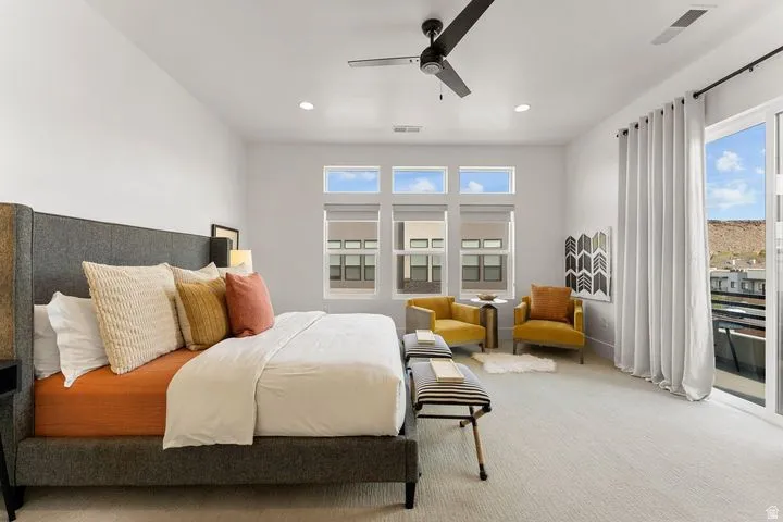 Bedroom with access to exterior, light colored carpet, ceiling fan, and recessed lighting