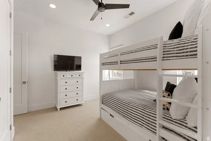 Bedroom featuring light carpet, a ceiling fan, and recessed lighting