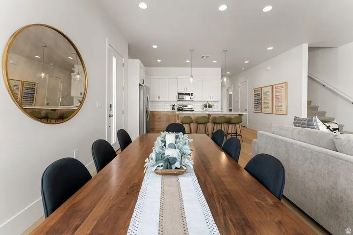 Dining space with recessed lighting and stairs