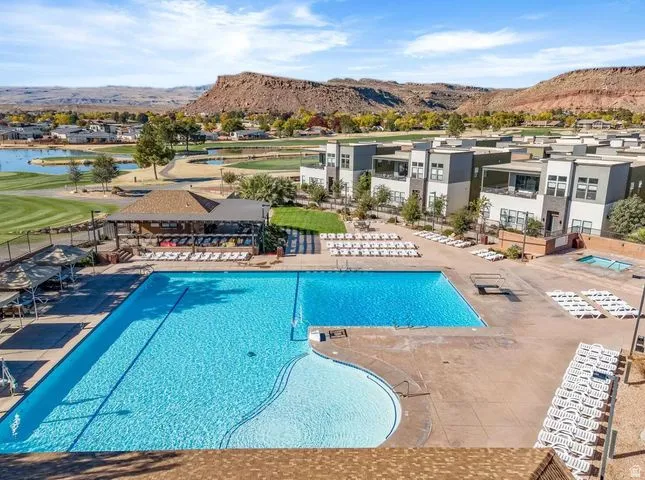 Community pool with a patio area, a residential view, and a water and mountain view