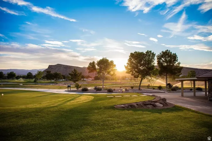 Surrounding community with a yard and a mountain view