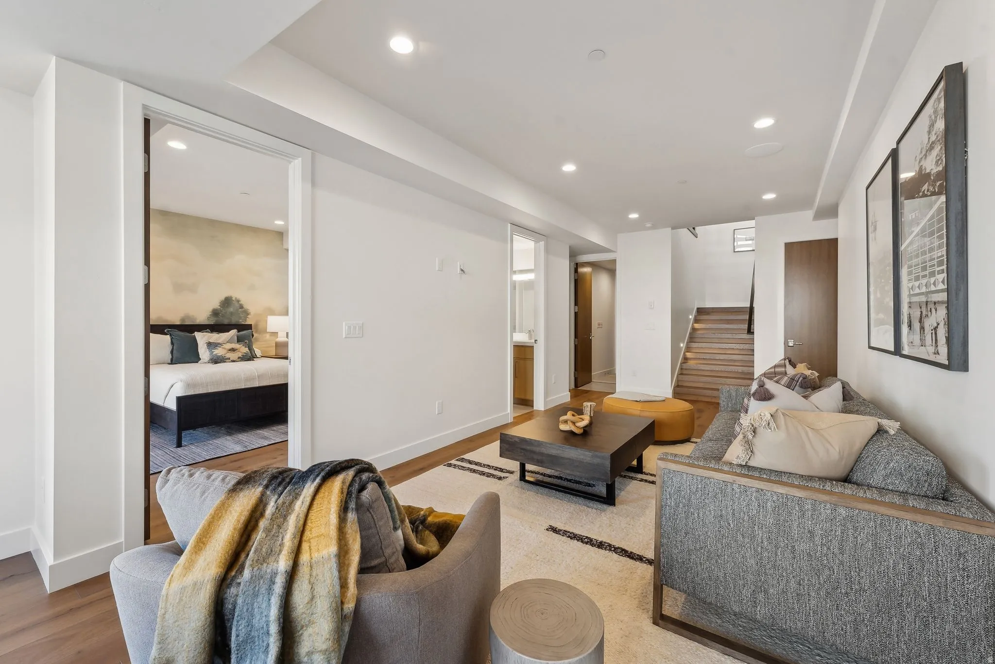 Living area with stairway, light wood-type flooring, and recessed lighting