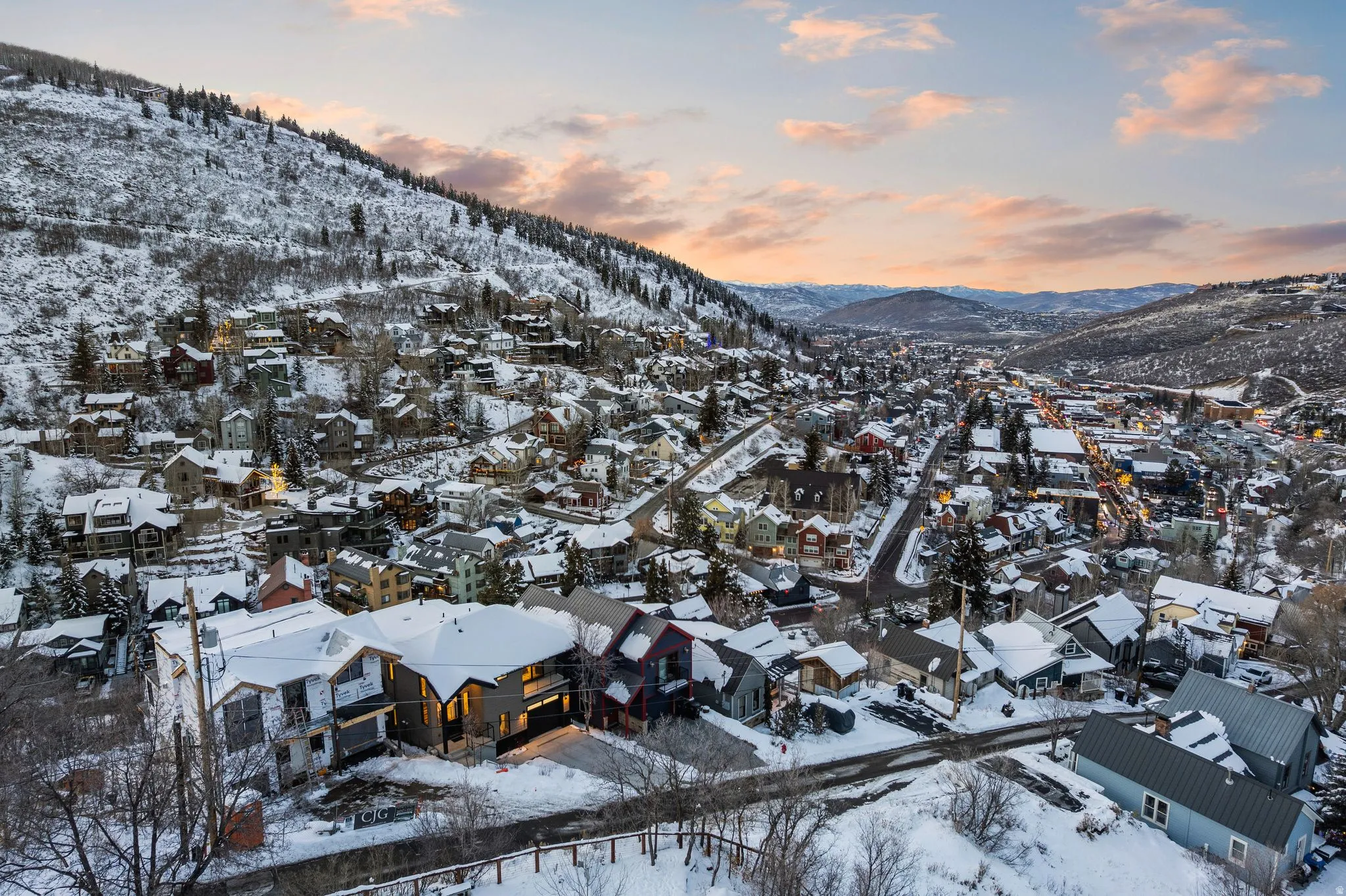 Snowy aerial view featuring a mountain view and a residential view