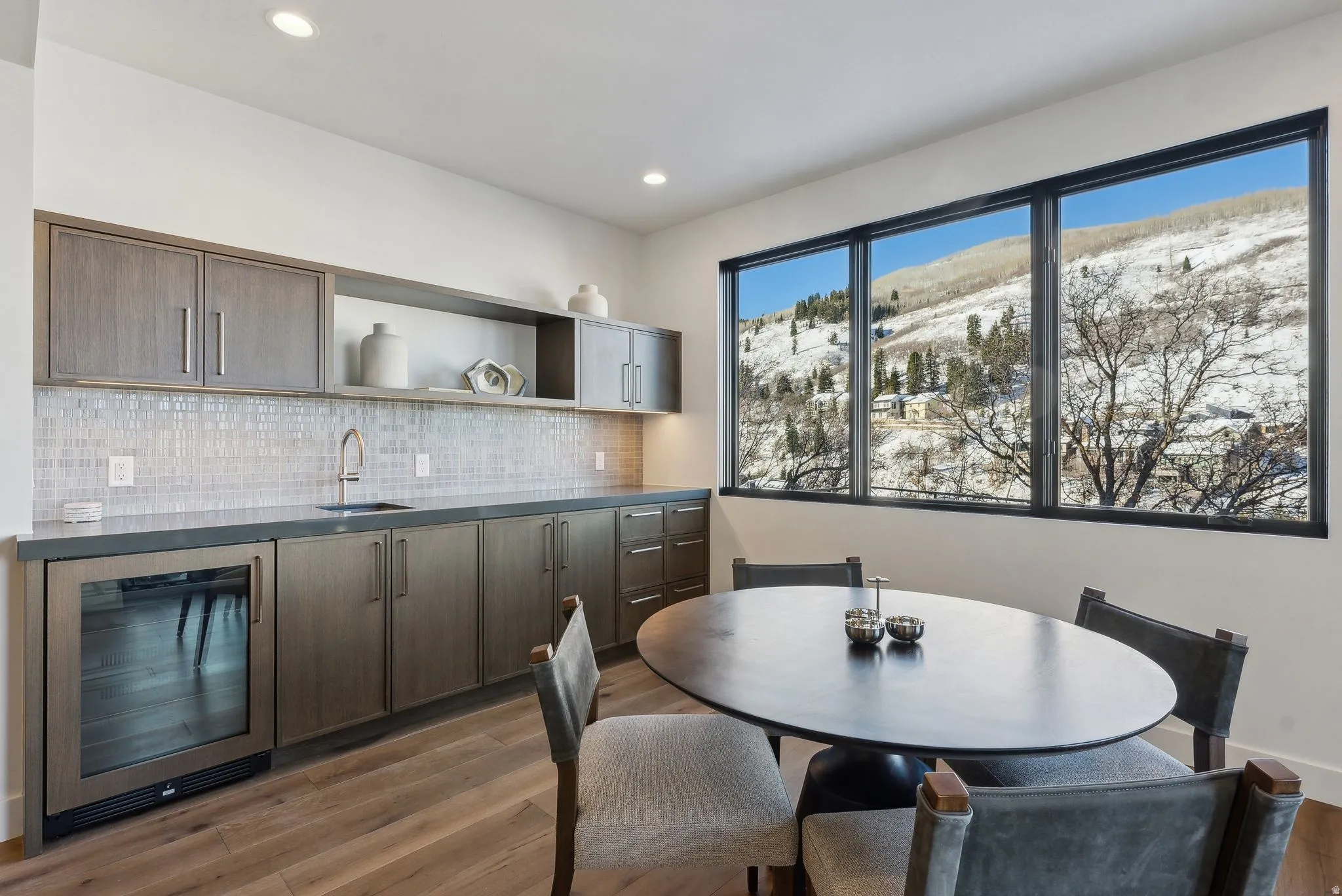 Dining area featuring beverage cooler, light wood-type flooring, and recessed lighting