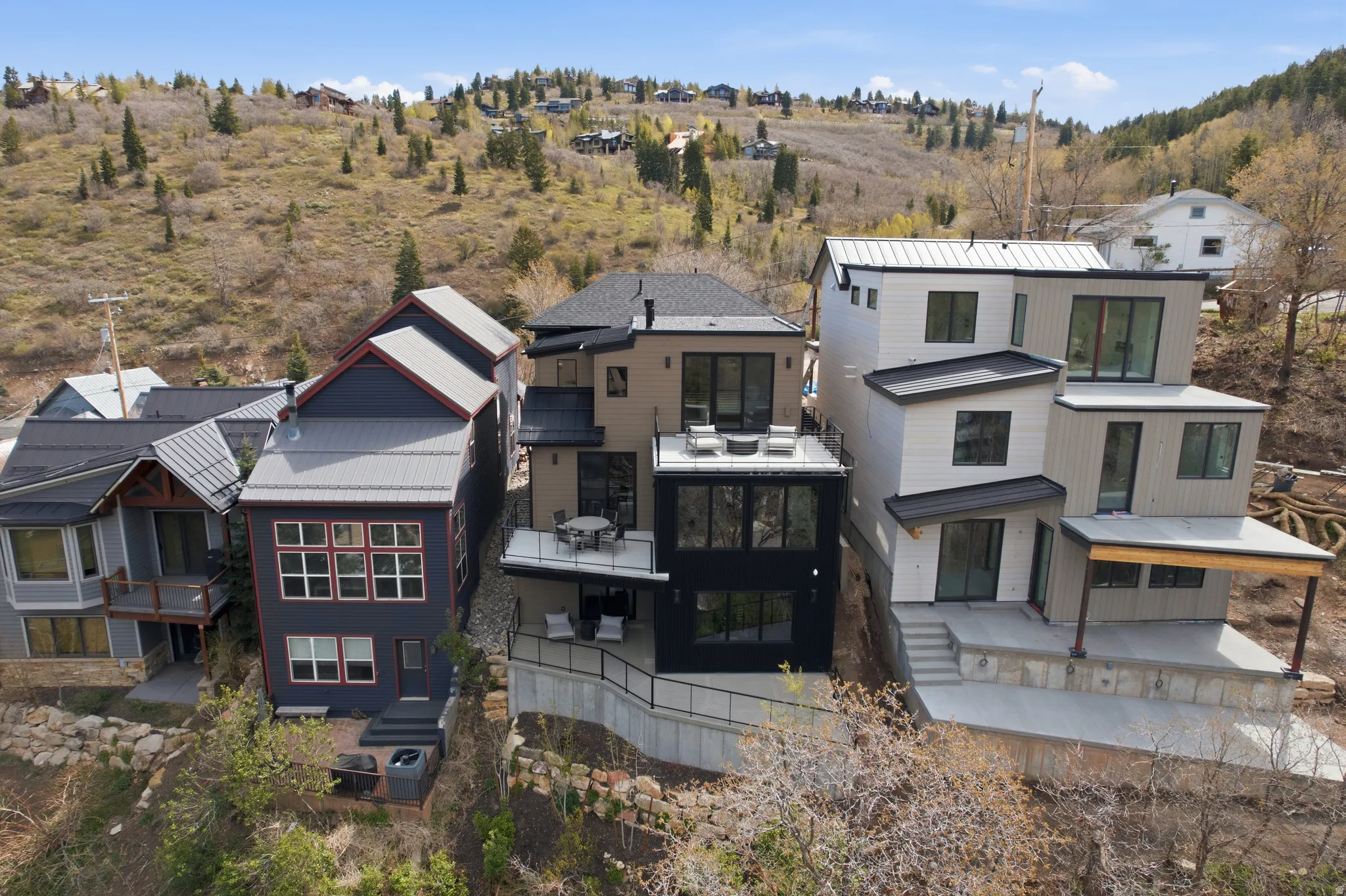 Modern multi-level residence with a tiered facade and multiple outdoor deck spaces