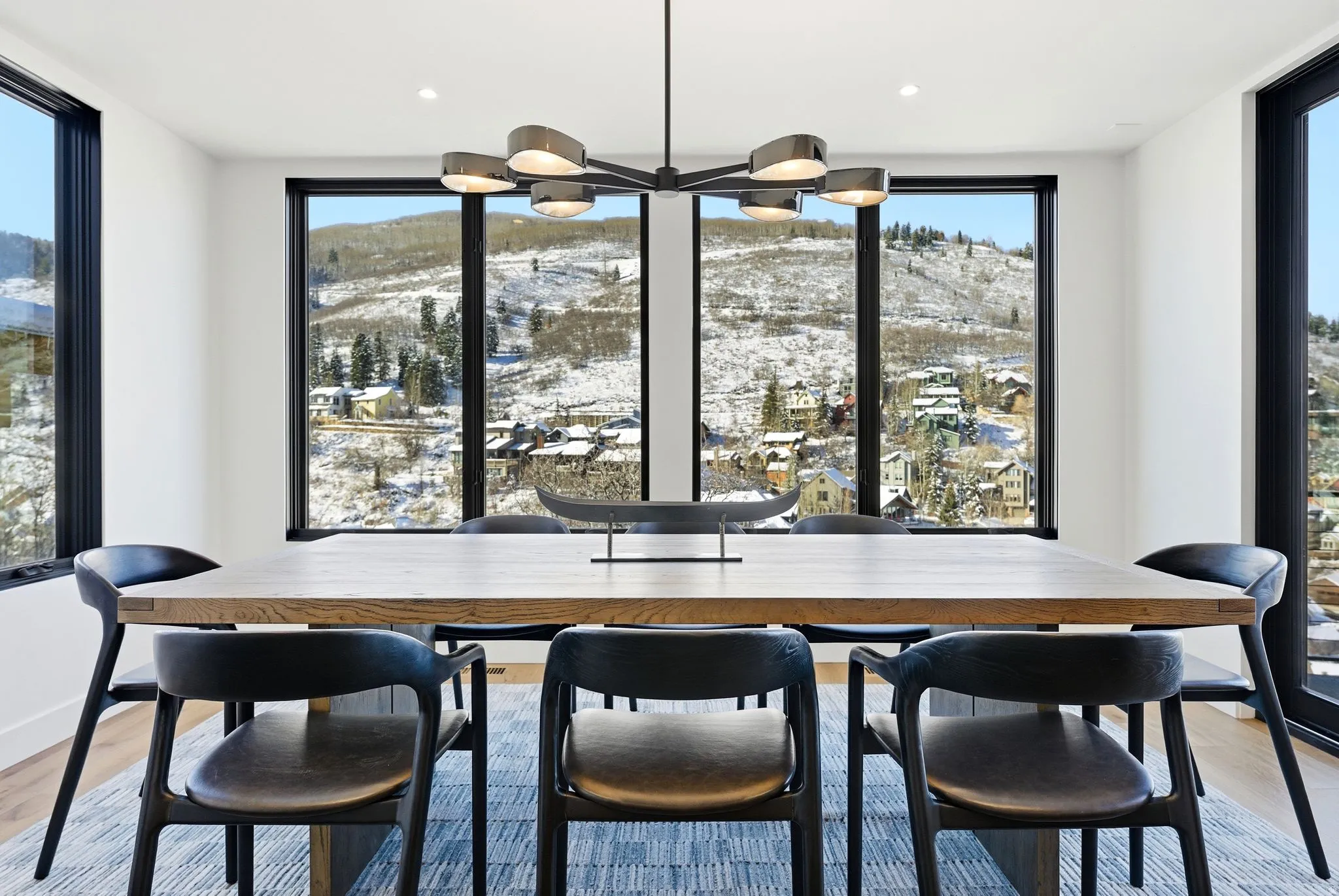Dining space with light wood finished floors, a mountain view, and a chandelier