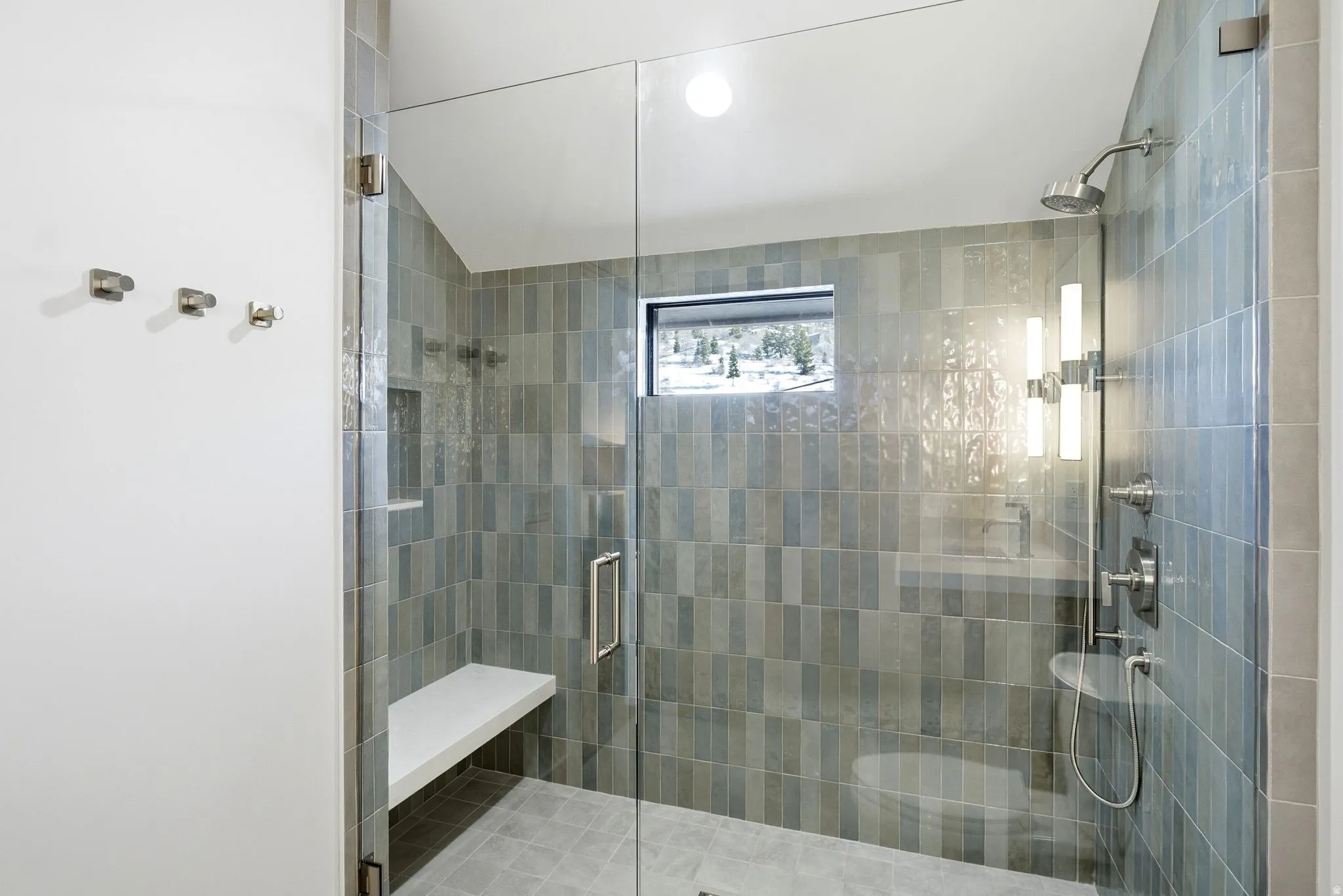 Full bathroom featuring a stall shower and vaulted ceiling