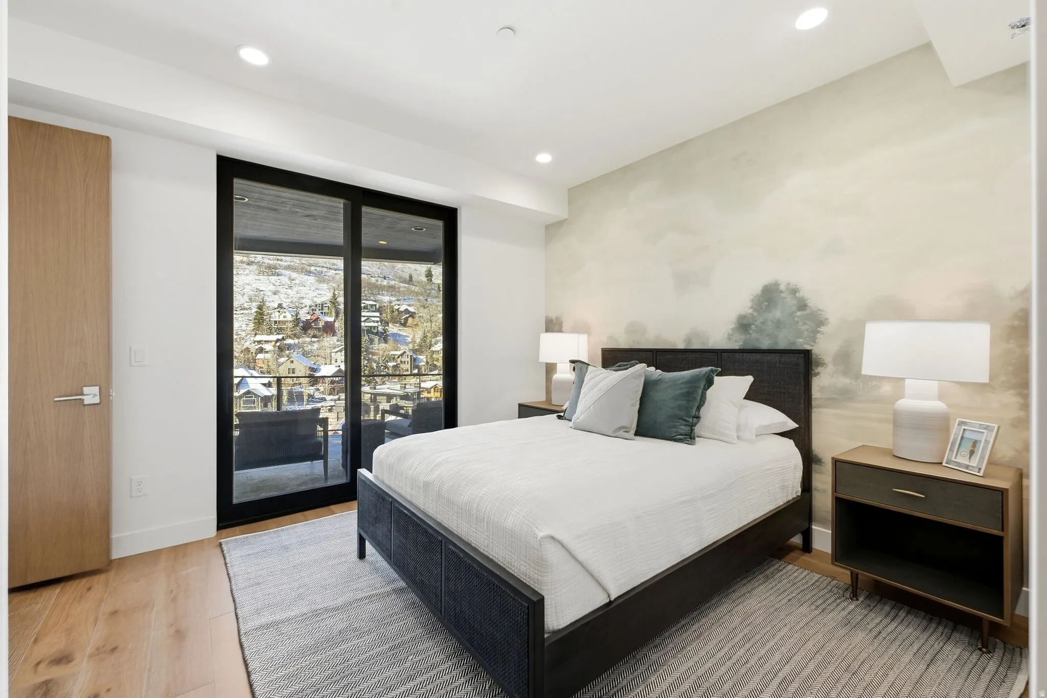 Bedroom with access to exterior, light wood finished floors, and recessed lighting