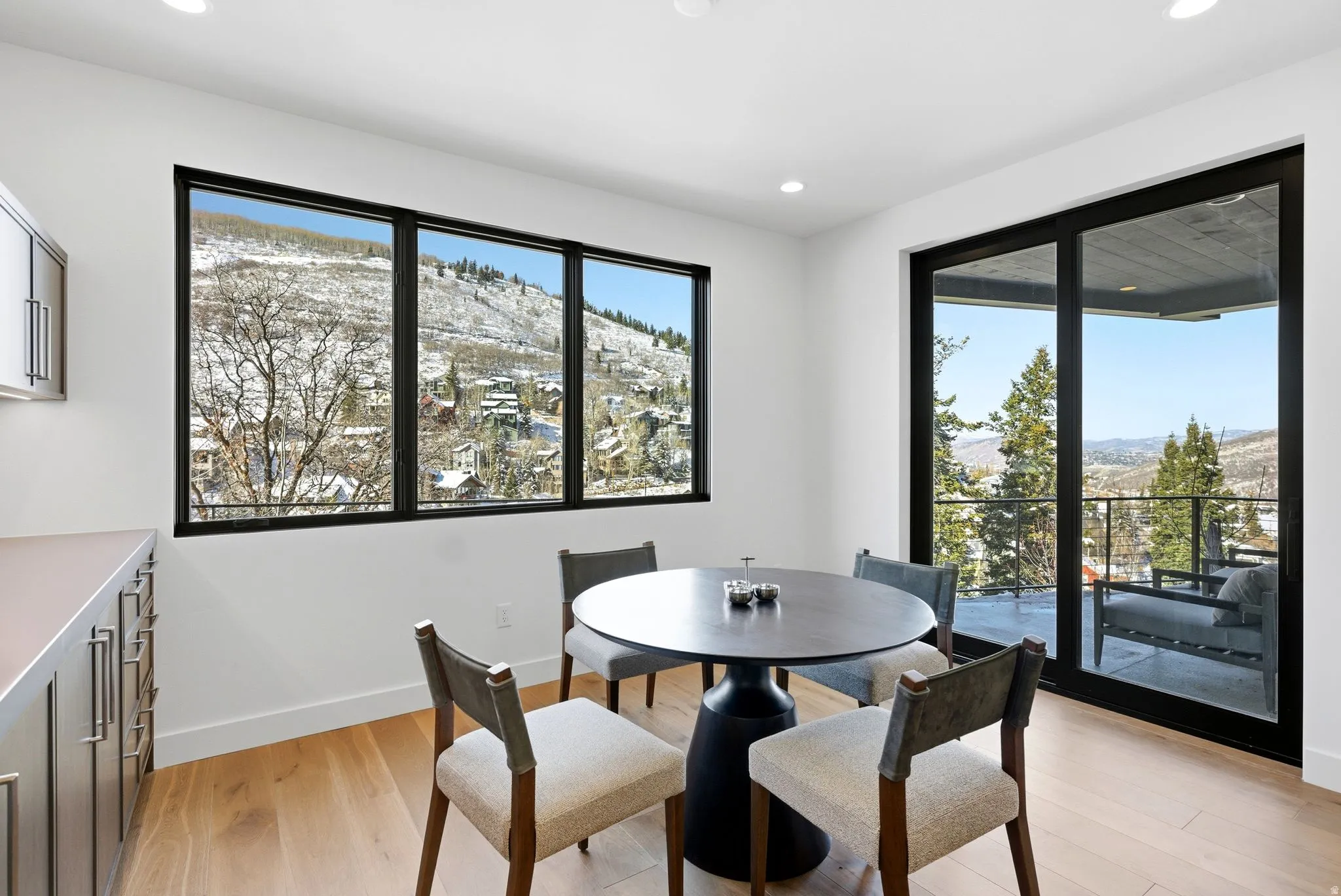 Dining space with a mountain view, light wood finished floors, and recessed lighting