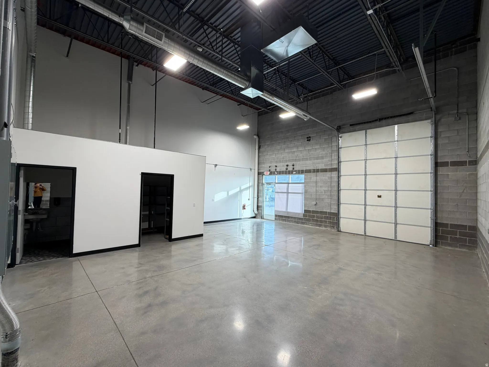 Garage featuring concrete block wall