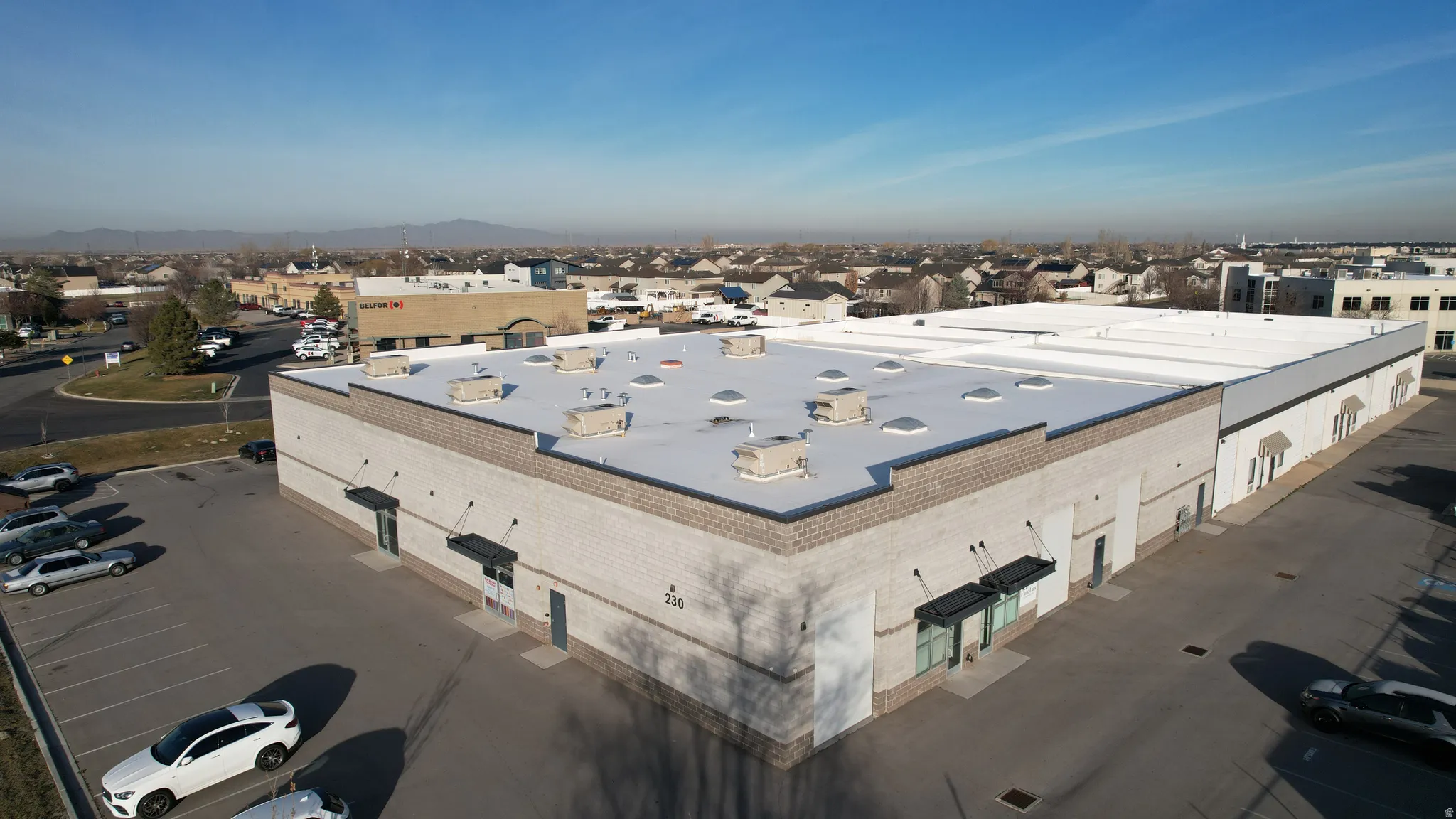 Industrial building with a light-colored brick facade and a flat roof