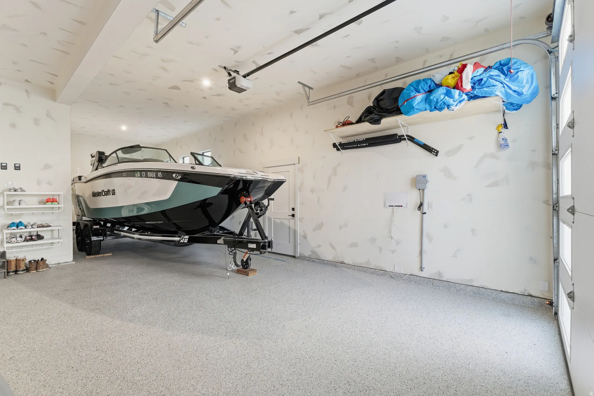 View of 4 car garage holding large boat