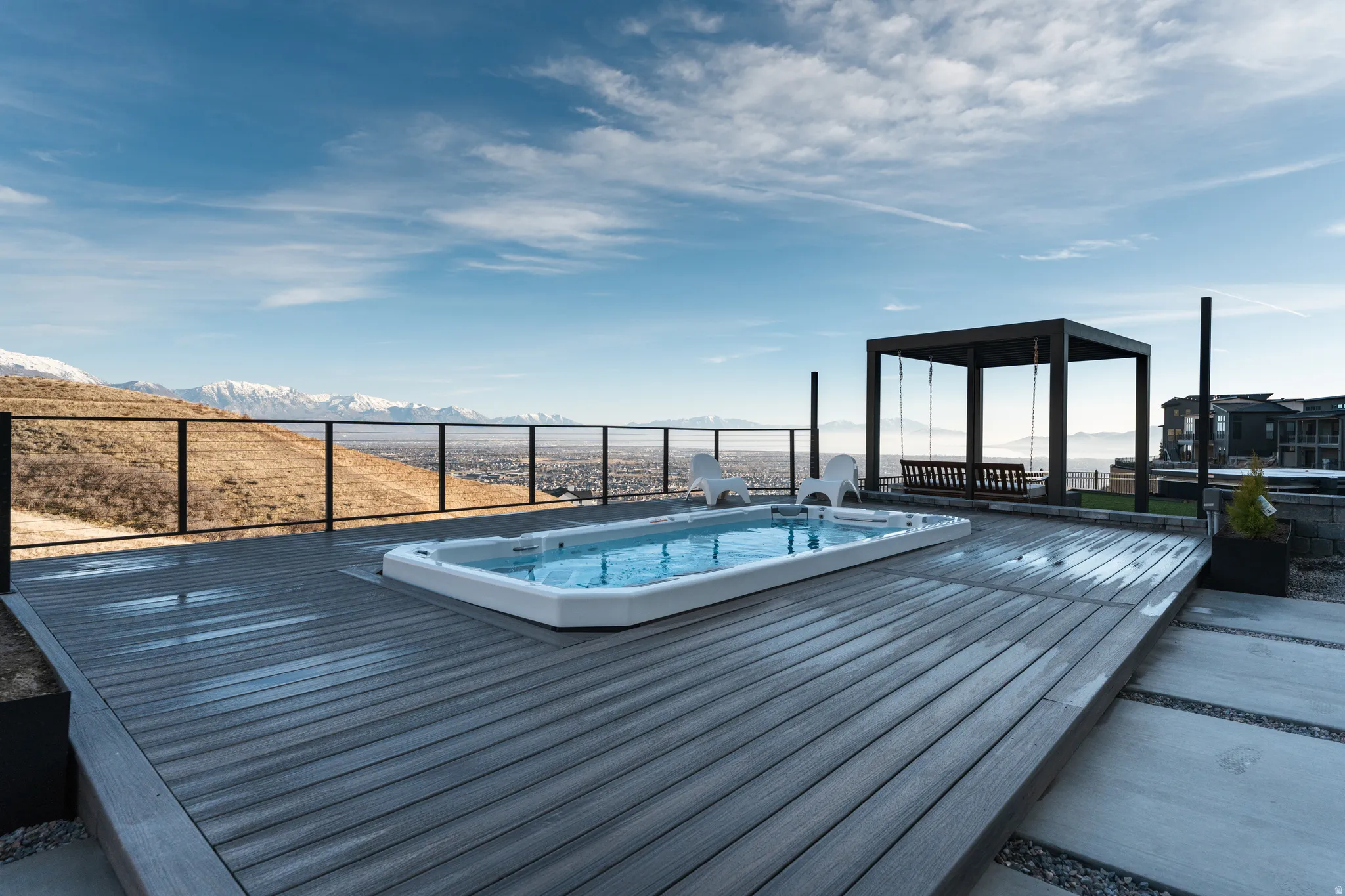 View of swimming spa with a deck with mountain view