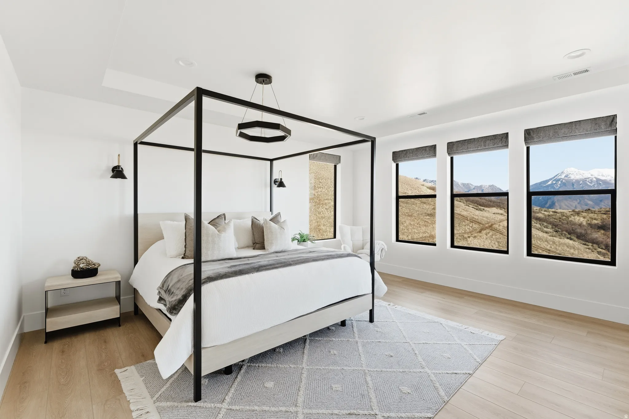 Bedroom with light wood finished floors and a mountain view